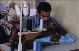  ?? PICTURES: REUTERS ?? Rohingya refugee, Muhammad Ayub, sews clothes at a market in Kuala Lumpur.