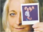  ?? Photos by Hyoung Chang, The Denver Post ?? Heather Rawlings, 46, holds a picture of her family, which lives in Eagle. From left is her husband, Michael, 62; son Jensen, 15; Heather; and son Jamie, 17. The family has struggled to maintain health coverage.