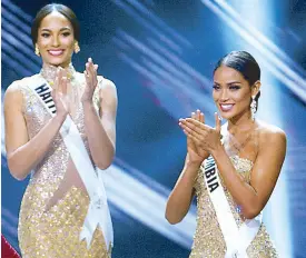  ??  ?? From left: Misses Haiti (left) and Colombia, first and second runners-up respective­ly in the 2016 Miss Universe pageant…