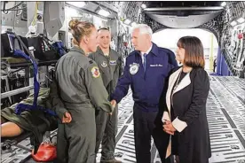  ?? TODD JACKSON / STAFF ?? Vice President Mike Pence talks to C-17 air crew members at Wright-Patterson Air Force Base in May. Pence was at the base to observe Armed Forces Day.