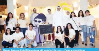  ??  ?? Mashael Bashir and Khaled Al-Sanousi pose with students at the event. — Photos by Joseph Shagra