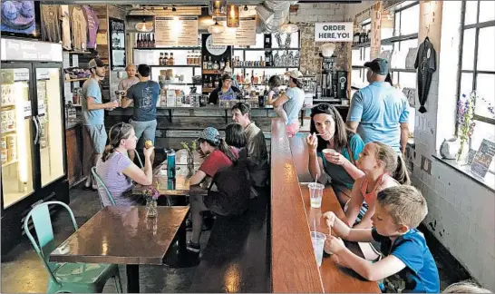  ?? LORI RACKL/CHICAGO TRIBUNE ?? Lexington’s Distillery District is home to Crank &amp; Boom Ice Cream Lounge, a fun spot to indulge in frosty treats like bourbon and honey ice cream.