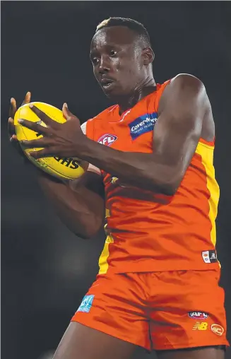  ?? ?? Mabior Chol is fighting to be fit for the QClash. Picture: Michael Willson/AFL Photos