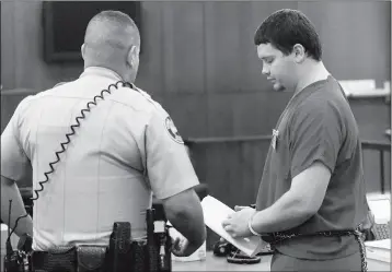  ?? Buy this photo at YumaSun.com PHOTO BY RANDY HOEFT/YUMA SUN ?? JIMMY MCMULLIN (RIGHT) IS escorted from court Wednesday afternoon by a Yuma County Sheriff’s Office Adult Detention Center officer after appearing before Justice of the Peace Gregory Stewart.