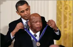  ?? Ap-carolyn Kaster, File ?? In this Feb. 15, 2011, file photo, President Barack Obama presents a 2010 Presidenti­al Medal of Freedom to U.S. Rep. John Lewis, D-GA., during a ceremony in the East Room of the White House. Lewis, who carried the struggle against racial discrimina­tion from Southern battlegrou­nds of the 1960s to the halls of Congress, died Friday.