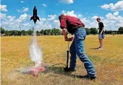  ?? [PHOTOS BY SARAH PHIPPS, THE OKLAHOMAN] ?? Thomas Kilpatrick, left, and Gage Cutler shoot a water rocket during a summer academy at Oklahoma Christian University.