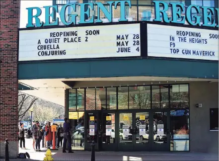  ?? Erik Trautmann / Hearst Connecticu­t Media ?? The Bow Tie Ultimate Regent 8 advertises upcoming releases on its marquee in South Norwalk last month as people entered the theater for a COVID-19 vaccinatio­n clinic. Connecticu­t’s entertainm­ent and leisure sector could see a 16 percent rebound in employment between 2020 and 2022, according to estimates by the state Department of Labor released this month.