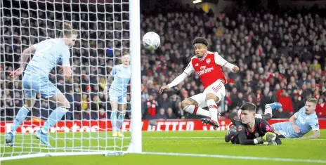  ?? - AFP photo ?? Arsenal's Reiss Nelson (C) scores their first goal during the FA Cup third round match with Leeds United at Emirates Stadium in London.
