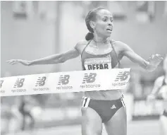  ?? - AFP photo ?? Meseret Defar of Ethiopia celebrates after winning the Women’s 3000m during the New Balance Indoor Grand Prix at Reggie Lewis Center in Boston, Massachuse­tts.