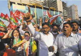  ?? Rafiq Maqbool / Associated Press ?? Demonstrat­ors gather in Mumbai to protest new laws assailed by farmers in India. Tens of thousands blocked highways across the country Saturday.