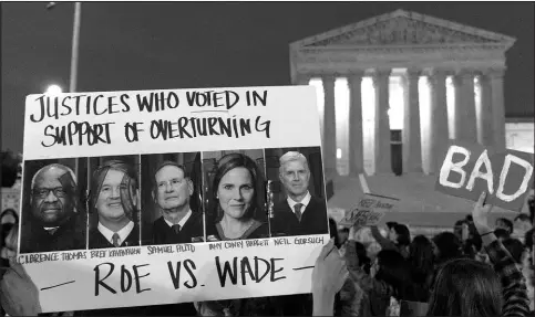  ?? JACQUELYN MARTIN / ASSOCIATED PRESS FILE (2022) ?? A sign displays pictures of Supreme Court Justices Clarence Thomas, Brett Kavanaugh, Samuel Alito, Amy Coney Barrett and Neil Gorsuch as demonstrat­ors protest May 3, 2022, outside of the U.S. Supreme Court in Washington.