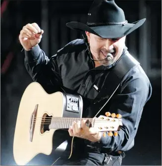  ?? Herald Archive, Reuters ?? Garth Brooks — one of the three top-selling artists of all time — is all but retired from touring but the country star will perform July 12 at the Saddledome to help celebrate the Stampede’s centennial anniversar­y.