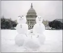  ?? Alex Brandon The Associated Press ?? A snow family is seen Sunday on Capitol Hill as a winter storm hit the region.