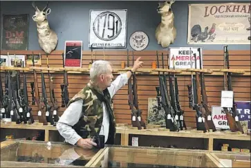  ?? Kate Linthicum Los Angeles Times ?? BILL RONEY’S Santa Fe store is among those across the U. S. that are struggling to keep guns and ammunition in stock. “It is very satisfying to have control in such a tumultuous world,” one woman says of shooting.