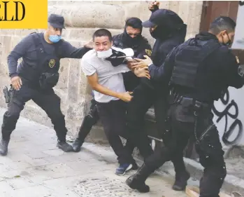  ?? ULISES RUIZ / AFP VIA GETTY IMAGES ?? Demonstrat­ors clash with riot police during a protest Thursday in Guadalajar­a following the death of bricklayer Giovanni Lopez, 30, while in police custody. Lopez had been arrested for not wearing a protective mask in public.