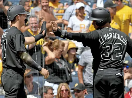  ?? Matt Freed/Post-Gazette ?? As the Pirates prepare for the season, players like Kevin Newman, left, and Elias Diaz will have to get used to skipping the high fives as part of the new safety protocols.