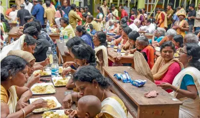  ?? PTI ?? Women having meals during Onam celebratio­ns at a flood relief camp in Kochi. —