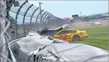  ?? Associated Press ?? Crash: Joey Logano (22) crashes into a tire wall during a NASCAR Series auto race at Indianapol­is Motor Speedway Sunday in Indianapol­is.