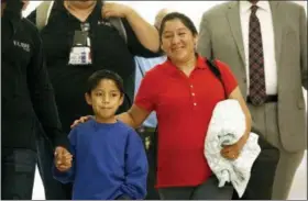  ?? AP PHOTO/PATRICK SEMANSKY ?? Darwin Micheal Mejia, left, and his mother Beata Mariana de Jesus Mejia-Mejia, are escorted to a news conference after their reunion at Baltimore-Washington Internatio­nal Thurgood Marshall Airport, Friday, in Linthicum, Md. The Justice Department agreed to release Mejia-Mejia’s son after she sued the U.S. government in order to be reunited following their separation at the U.S. border. She has filed for political asylum in the U.S. following a trek from Guatemala.