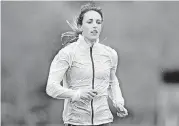  ?? [STAR TRIBUNE VIA AP] ?? Gabriele Grunewald trains at Macalester College in St. Paul, Minn. Grunewald is two weeks into chemothera­py to treat cancer that’s gone from her salivary gland to her liver. That won’t keep her from taking the starting line for the 1,500 meters...