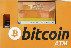  ?? Kin Cheung / Associated Press ?? This bitcoin ATM is in Hong Kong. Bitcoin has fallen sharply in recent days.