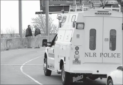  ?? Arkansas Democrat-Gazette/STATON BREIDENTHA­L ?? In this March 15 photo, North Little Rock Police investigat­e a double fatality collision on the Main Street Bridge that killed John Blanks and Ricky Anderson. Blanks, police say, was driving on the wrong side of the road when he hit Anderson, who was...