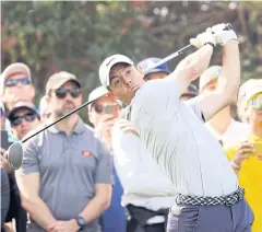  ?? AFP ?? Rory McIlroy plays his shot from the 11th tee during the third round.