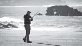  ?? AP PHOTO/ERIC RISBERG ?? Phil Mickelson hits from the No. 18 fairway of the Pebble Beach Golf Links course Monday in the AT&amp;T Pebble Beach Pro-Am in Pebble Beach, Calif. Mickelson won the tournament after finishing at 19 under par.