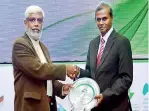  ??  ?? Assistant General Manager (Plant and Technical) Lanka Tiles PLC Patrick Piyasena (right) receiving the award at the Green Building Awards 2015
