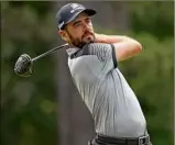  ?? Gregory Shamus / Getty Images ?? Troy Merritt plays his shot from the fourth tee during the third round of the Rocket Mortgage Classic. He shot 67 to share the lead with Joaquin Niemann.