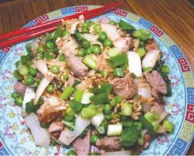  ?? LINDA GASSENHEIM­ER/TRIBUNE NEWS SERVICE ?? This pork fried rice is flavored with bottled hoisin sauce.