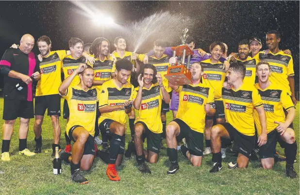  ?? Pictures: BRENDAN RADKE ?? FIGHTING WIN: Edge Hill Tigers players celebrate winning the FNQ Football men's 2018 grand final at Endeavour Park, Manunda.