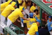  ?? MARY SCHWALM — THE ASSOCIATED PRESS ?? Red Sox first baseman Triston Casas is congratula­ted in the dugout after hitting a three-run home run during a game against the Orioles on Sunday, Sept. 10, 2023 in Boston. The players were wearing the popular yellow City Connect uniforms.