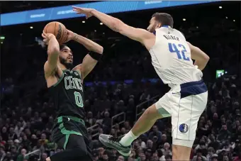  ?? MICHAEL DWYER — THE ASSOCIATED PRESS ?? Boston Celtics’ Jayson Tatum (0) looks to shoot against Dallas Mavericks’ Maxi Kleber (42) during the first half of an NBA basketball game, Friday, March 1, 2024, in Boston.