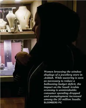  ?? BLOOMBERG PIC ?? Women browsing the window displays of a jewellery store in Jeddah. While austerity is seen as necessary to reduce a ballooning budget deficit, the impact on the Saudi Arabia economy is unmistakab­le: consumer spending dropped and unemployme­nt increased...