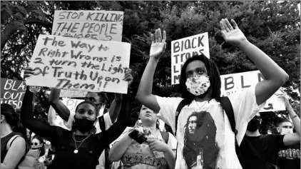  ?? Photo/Rich Pedroncell­i
AP ?? Demonstrat­ors hold up their hands during a rally in Sacramento, Calif., Tuesday protesting the death of George Floyd. Floyd died May 25 after being restrained by Minneapoli­s police.