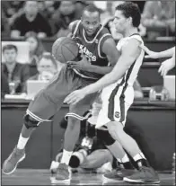  ?? McClatchy Newspapers/C. MICHAEL BERGEN ?? Arkansas forward Marshawn Powell (left) works against South Carolina’s Michael Carrera in the first half of the Gamecocks’ 75-54 victory Saturday in Columbia, S.C. Powell led the Razorbacks with 22 points and 13 rebounds.