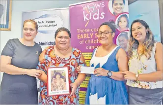  ?? Picture: JONACANI LALAKOBAU ?? Fiji Public Trustee Corporatio­n Ltd estate and trust manager Salaseini Drekeni, second left, holds a photo frame of the late Joyce Danraijie Heeraman as WOWS Kids founder Sina Kami, left, team leader Viola Lesi, with cheque, and Fiji Public Trustee manager legal Priya Lal looks on during the handover of the at the Fiji Public Trustee office in Toorak, Suva yesterday.