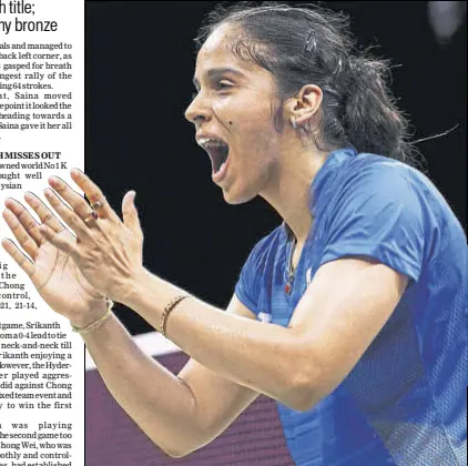  ?? REUTERS ?? Saina Nehwal exults after beating PV Sindhu 2118, 2321 to win the women’s singles gold on the final day of the Commonweal­th Games in Gold Coast on Sunday.