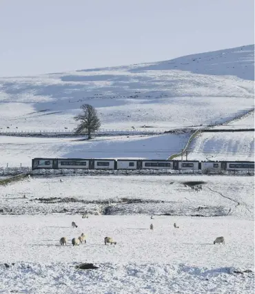  ??  ?? 0 A tranquil winter scene at Abington in South Lanarkshir­e, but snow caused disruption in the south