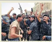  ??  ?? WE’RE WINNING Iraqi police dance in the streets