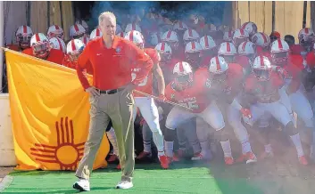  ?? JIM THOMPSON/JOURNAL ?? Bob Davie leads the Lobos onto the field for the 2019 season-opener against Sam Houston State.