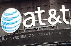  ?? AP ?? The AT&T logo is positioned above one of its retail stores, in New York.