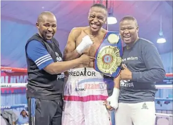  ?? /SUPPLIED ?? SA super middleweig­ht champion Asemahle Wellem celebrates his win with trainer Phumzile Matyhila and manager Siya Zingelwa.