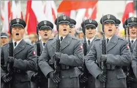  ?? Alik Keplicz ?? The Associated Press Polish soldiers salute during the official ceremony Sunday in Warsaw marking the nation’s Independen­ce Day.