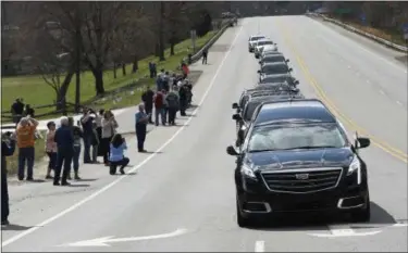  ?? KATHY KMONICEK — THE ASSOCIATED PRESS ?? People line the street as the hearse carrying the body of Rev. Billy Graham leaves the Billy Graham Training Center at the Cove on Saturday in Asheville, N.C.