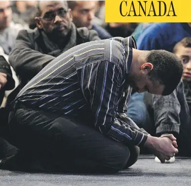  ?? PAUL CHIASSON/AFP/GETTY IMAGES ?? Mourners pray during funeral services for victims of the massacre at the Quebec Islamic Cultural Centre in Quebec City on Feb. 3. Nine months later, Muslim leaders say members of the community are still being targeted for abuse.