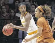  ?? WADE PAYNE / AP ?? Tennessee guard Diamond DeShields looks to pass as she’s guarded by Texas’ Empress Davenport on Sunday. DeShields had 24 points and 11 rebounds.