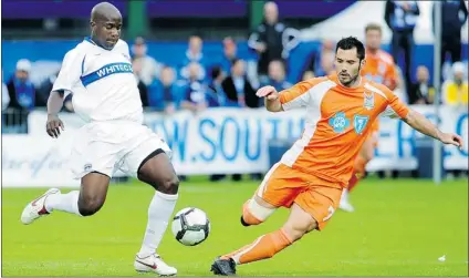  ?? RIC ERNST/ PNG FILES ?? Vancouver Whitecap Nelson Akwari ( left) clears the ball away from the Carolina Railhawks’ Etienne Barbara in a 2010 game.