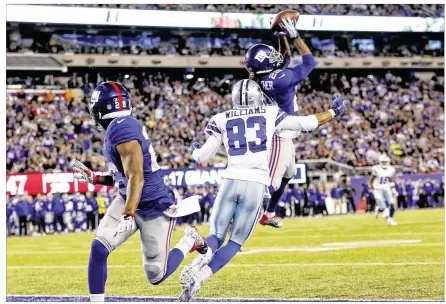  ?? KATHY WILLENS / ASSOCIATED PRESS ?? Giants strong safety Brandon Meriweathe­r intercepts a second-half pass intended for Cowboys wide receiver Terrance Williams. Dominique Rodgers-Cromartie had two intercepti­ons for the Giants, returning one 58 yards for a touchdown.